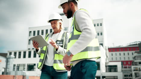 construction workers reviewing plans on a tablet