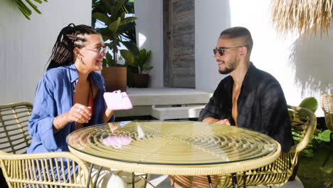 Couple-sitting-on-a-terrace