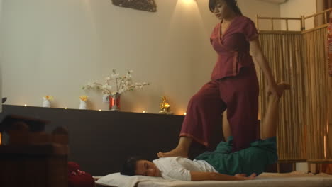 asian beautiful young woman enjoying relaxing receiving back massage and essential oil aroma therapy in cosmetology spa salon center. body skin care beauty treatment concept.