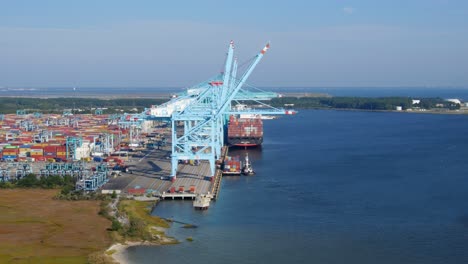 Aerial-video-of-Port-operations-end-boom-shot-showing-container-barge-being-unloaded