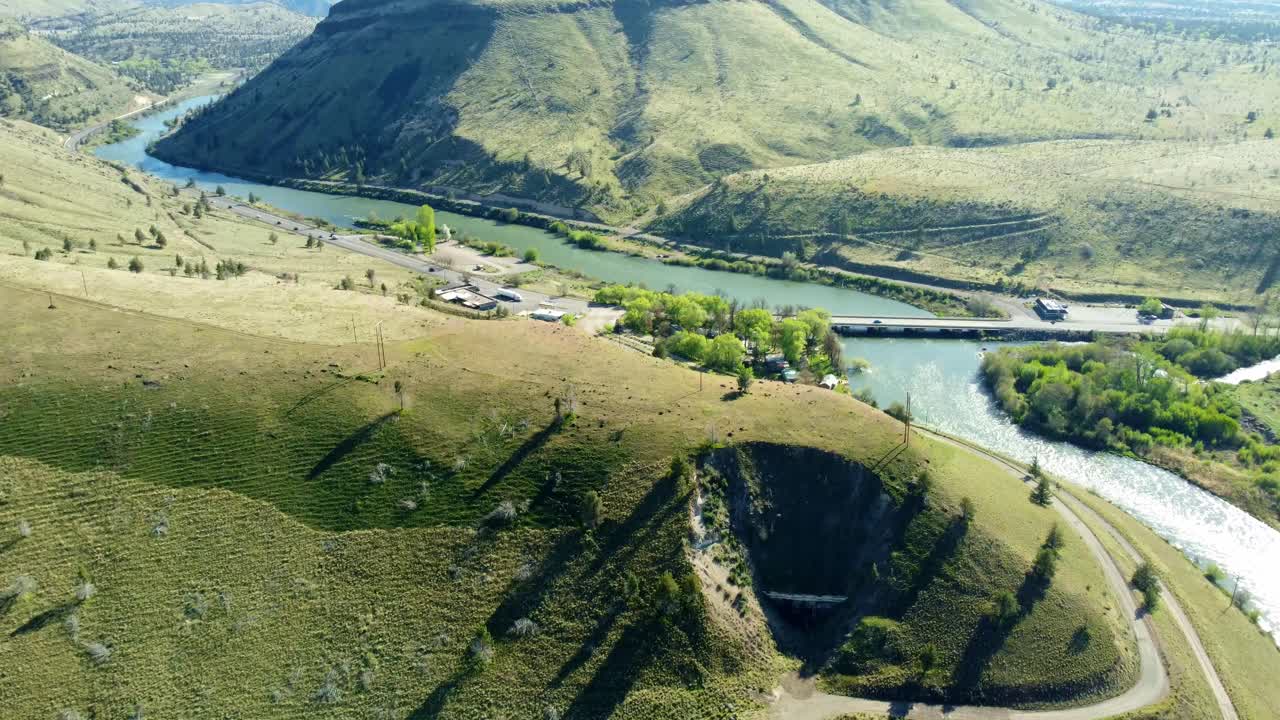 US, Oregon, Warm Springs, , 2025-04-19 - Drone view of an old abandoned train tunnel built in 1906 on the Deschutes River. The highway is US Hwy 26