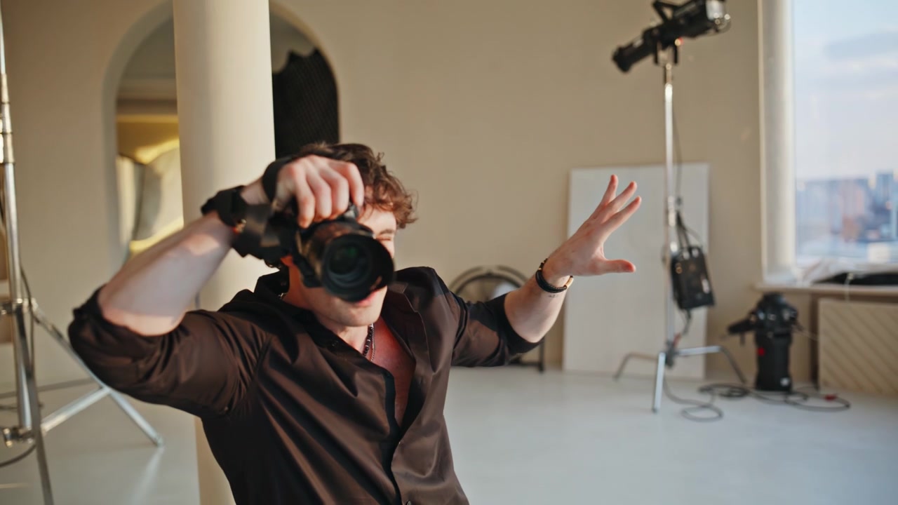 Photographer gesturing directions studio. Man shooting camera photoshoot