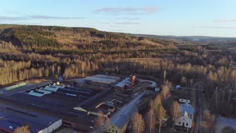 drone rising over industry building in bongbro, sweden