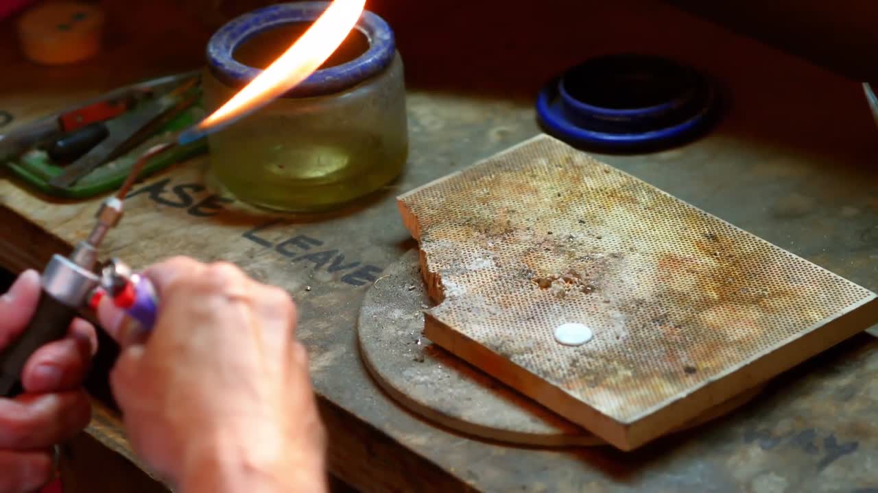 Craftswoman using blowtorch