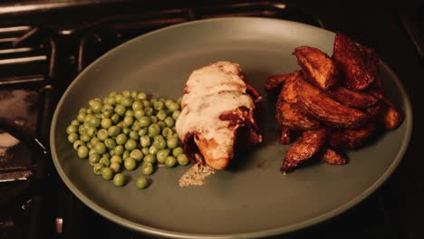 Plated-PlantBased-Chicken-Fillet-Wrapped-in-Vegan-Bacon-with-Paprika-Potato-Wedges-and-Peas