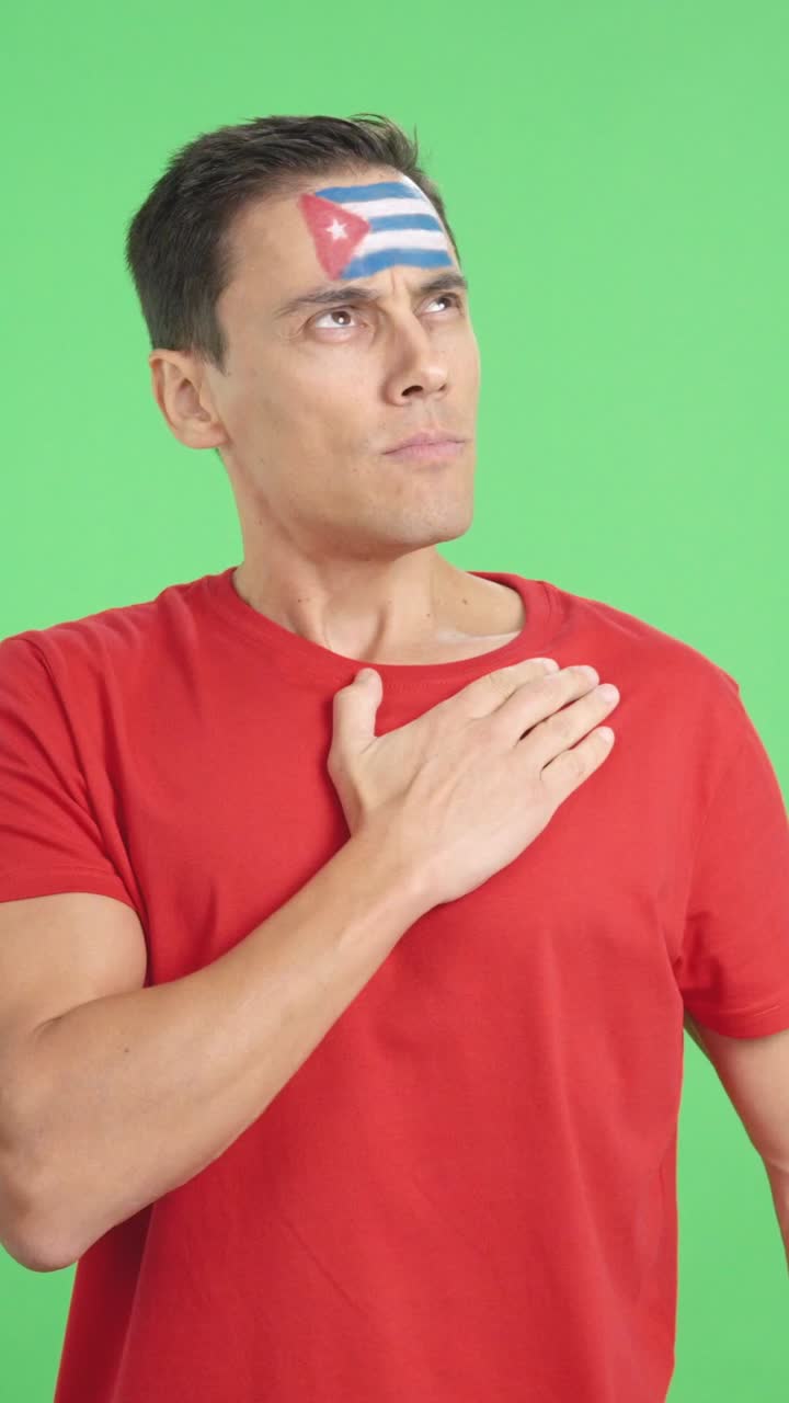 Man listening to the Cuba national anthem with solemnity