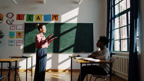 teacher instructing a student in a classroom