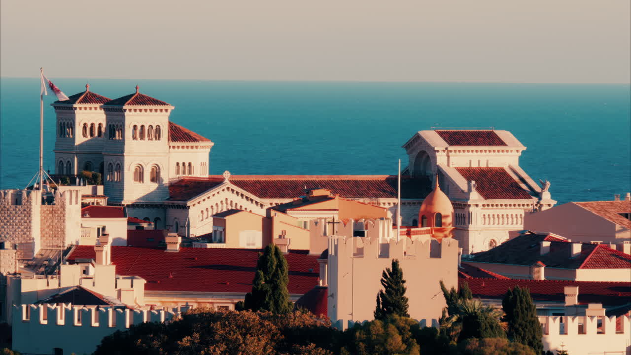 Distant aerial view of the Prince's Palace in the skyline of Monaco with the sea on the background