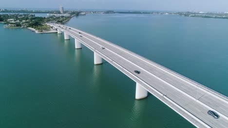 aerial pan and tilt of the john ringling causeway bridge revealing the beautiful bay in sarasota florida