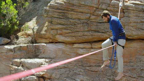 Mountaineer-trying-to-get-on-the-rope-for--tightrope-walking-4k