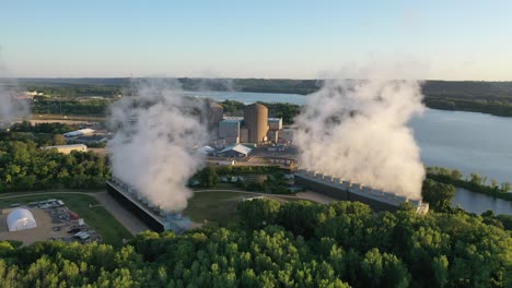 aerial view of nuclear power plant with cooling towers and river