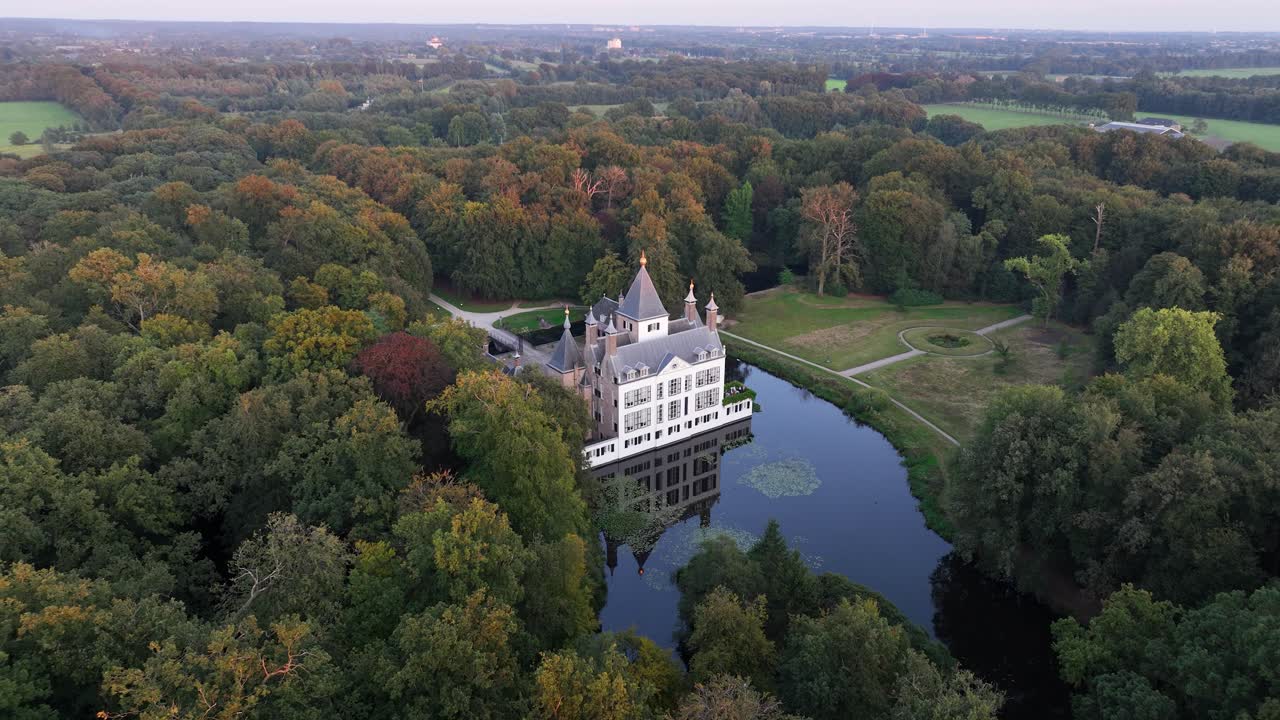 Renswoude castle, romantic historic castle in forrest nature. Aerial drone video.