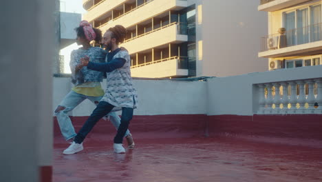 couple improvising and performing tango dance on a wet rooftop