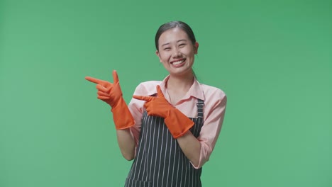 mujer con guantes naranjas y delantal apuntando