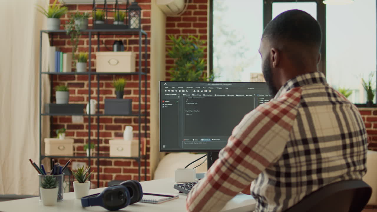 Male app developer using html script code on computer