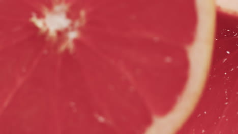 micro video of close up of slices of red grapefruit with copy space