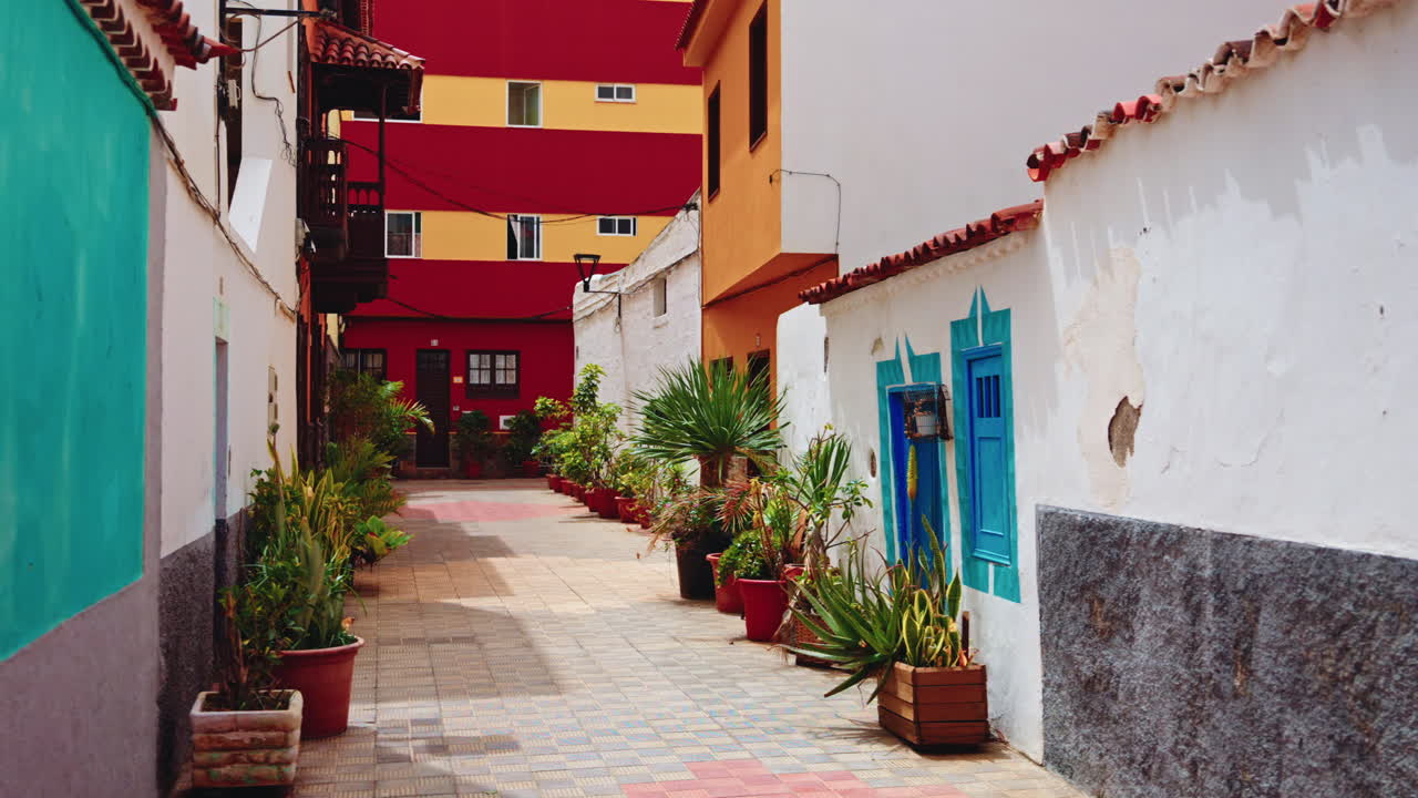 Walking through the narrow empty streets of Tenerife, Canary Islands, Spain. View of the facades of the buildings and typical architecture of a local small town. Summer holidays destination.