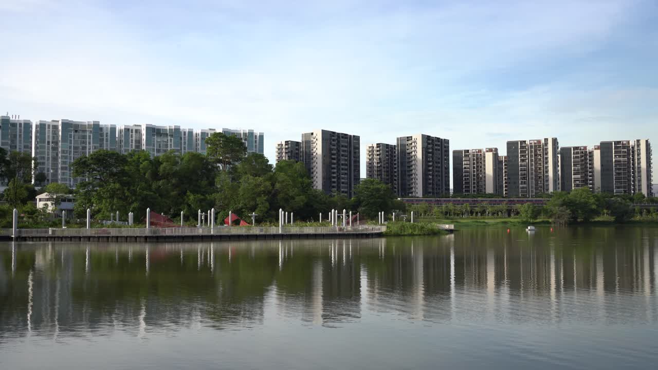Beautiful tranquil view of the lake with reflection of residential estate on the calm water and MRT train passing through in Jurong Lake Gardens, Singapore.