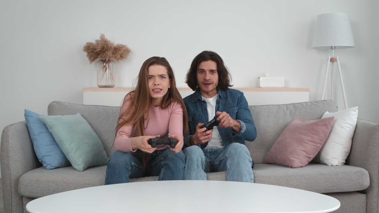 Couple Playing Video Games on a Sofa