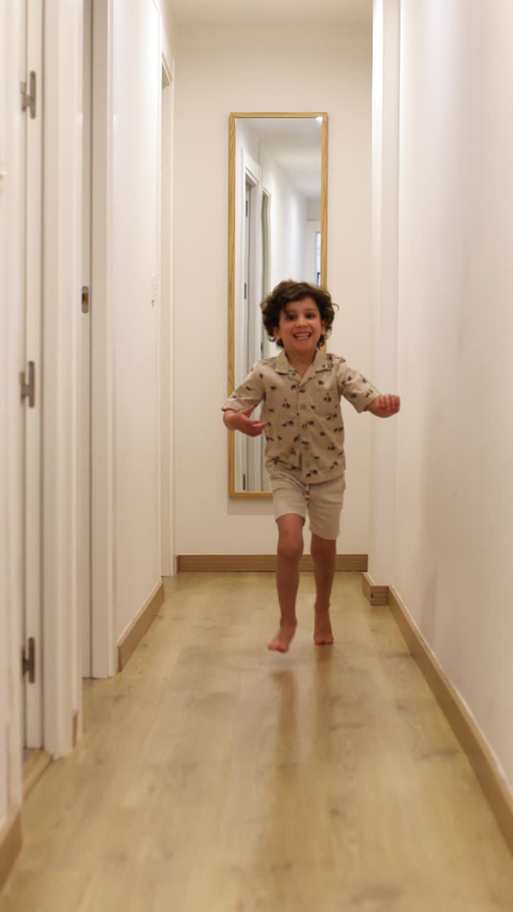 Happy child running in corridor at home