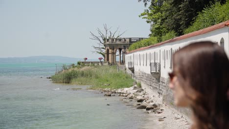 Woman-Looking-out-at-Lake-Constance-Bodensee-on-Shore-of-Friedrichshafen,-Germany