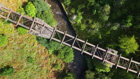 an aerial drone shot looking down on an abandoned bridge in south wales with a rotating view