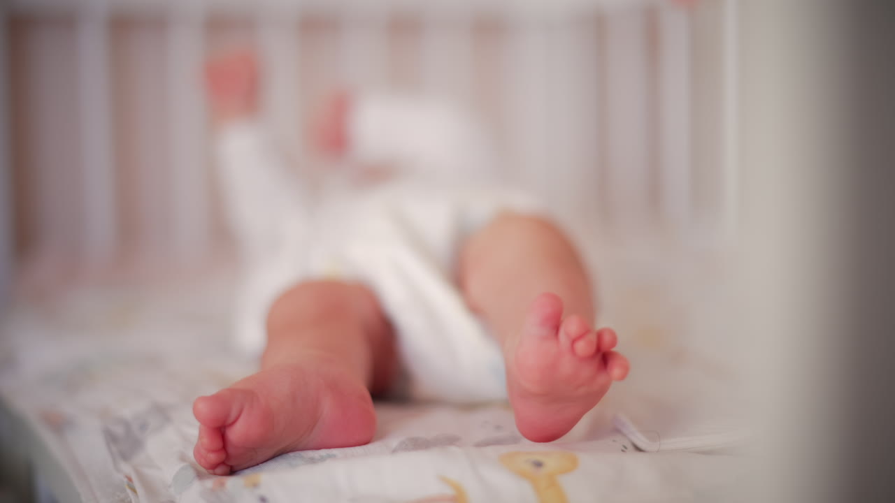 Close up of baby's feet moving around on a bed