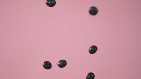 Blueberries-Fall-Down-Against-A-Pink-Wall