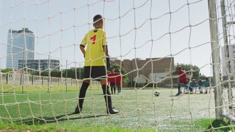 African-American-kid-in-red-scoring-in-a-sunny-day