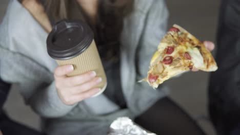 close-up of people hands taking slices pizza from food delivery open box. tasty service to office. focus changes from hands and goes up to show business people in the office. shot in 4k