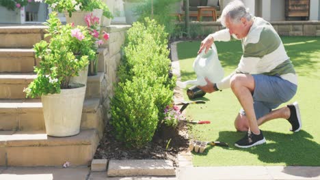 Happy-caucasian-senior-man-working-in-garden-on-sunny-day