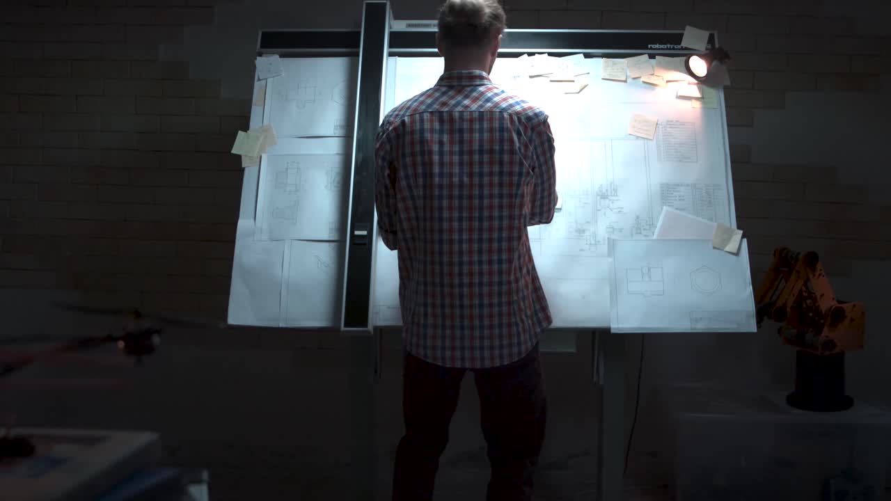 Engineer working on blueprints in a design studio.