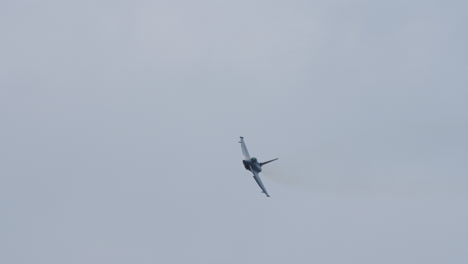 military jet aircraft flying directly toward the camera with visible front view and cloudy sky in the background