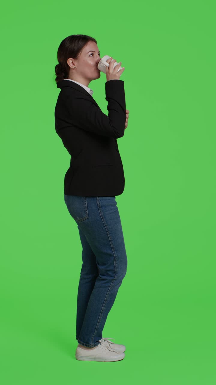 Vertical video: Profile of corporate employee enjoying cup of coffee on camera