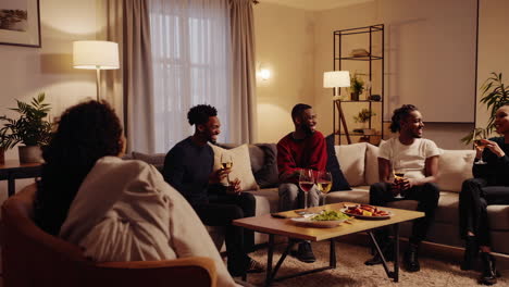 friends laughing and toasting at a home party