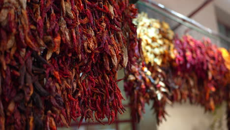 dried peppers hanging in a market