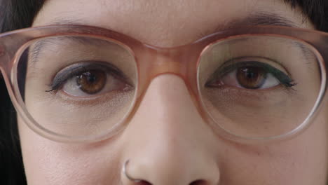 close up young woman brown eyes looking at camera wearing stylish glasses eye care concept