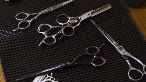 Detail-of-barbershop-hairdressing-tools-on-wooden-table-elevated-view