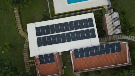 Aerial-view-of-roofs-of-a-club-house-with-photovoltaic-solar-panels,-Ciudad-Campestre-residential-area,-El-Castillo,-Jamundi,-Valle-del-Cauca