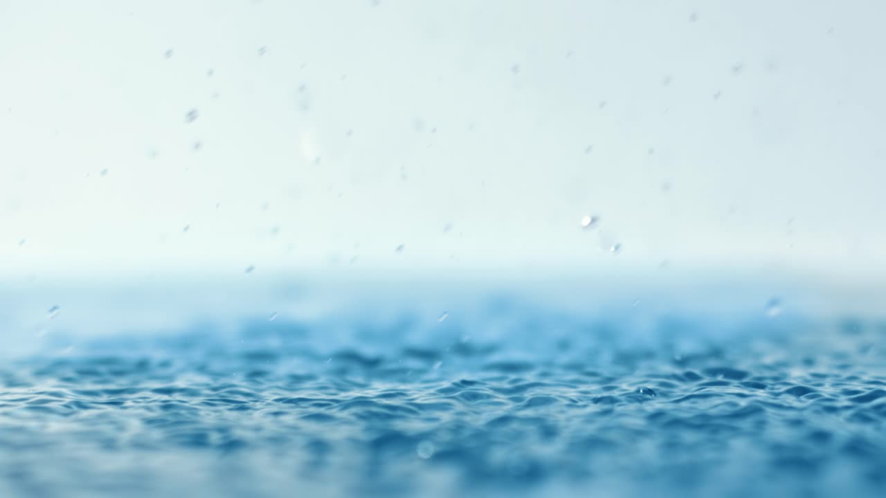 Rain water drops falling in super slow motion.