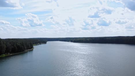 High-altitude-flyover-of-Lake-Jezioro-Gwiazdy-in-Borowy-Młyn-in-Kaszuby,-Pomeranian-Voivodeship,-Poland