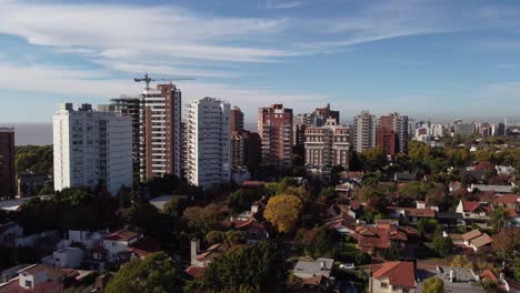 aerial pedestal up of san isidro residential area in buenos aires with skyscrapers and crane on construction site