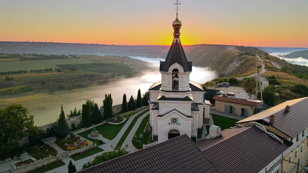 Aerial drone view of the Old Orhei at sunset. Valley with river and fog, monastery located on a hill in Moldova