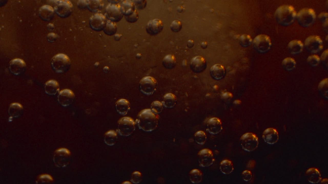Close-up of Bubbles in a Dark Carbonated Drink