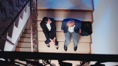 top view of overworked businesspeople talking on stairs