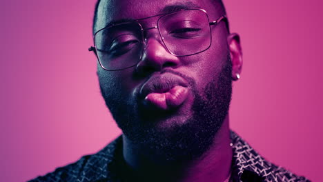 African-american-guy-making-kiss-in-studio.-Fancy-man-staring-at-lens-indoors