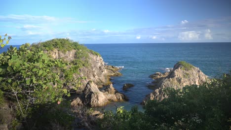 a sunset along the coastline. rocky coast.
