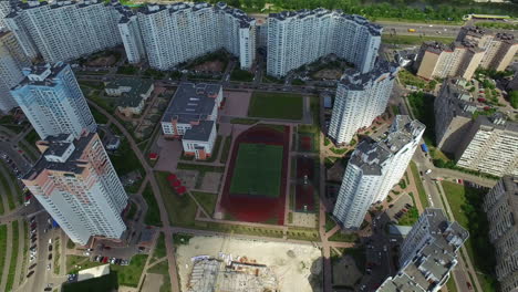 aerial view residential area with high rise building and school sport ground