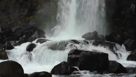 water flowing down on the rocks at oxararfoss waterfall in thingvellir national park, iceland