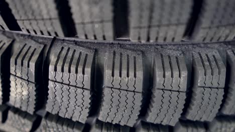 many new winter tires on shelves and in columns. panorama of the store.